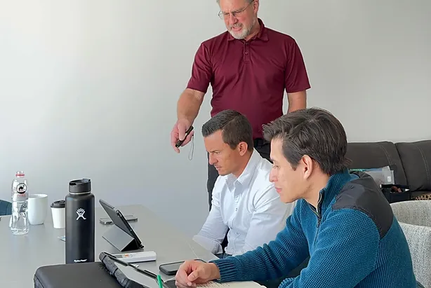 A teacher and two students with a computer